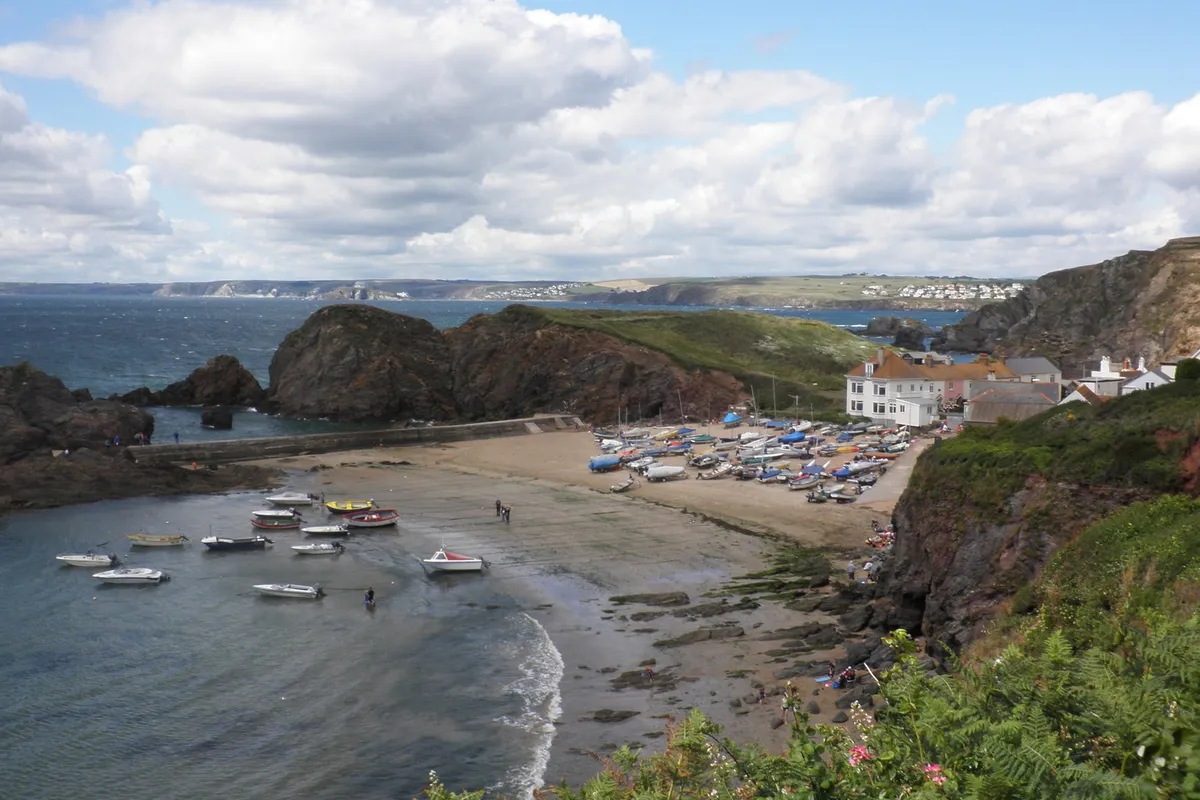 Hope Cove beneath the headland of Bolt Tail, with the beach at low tide
