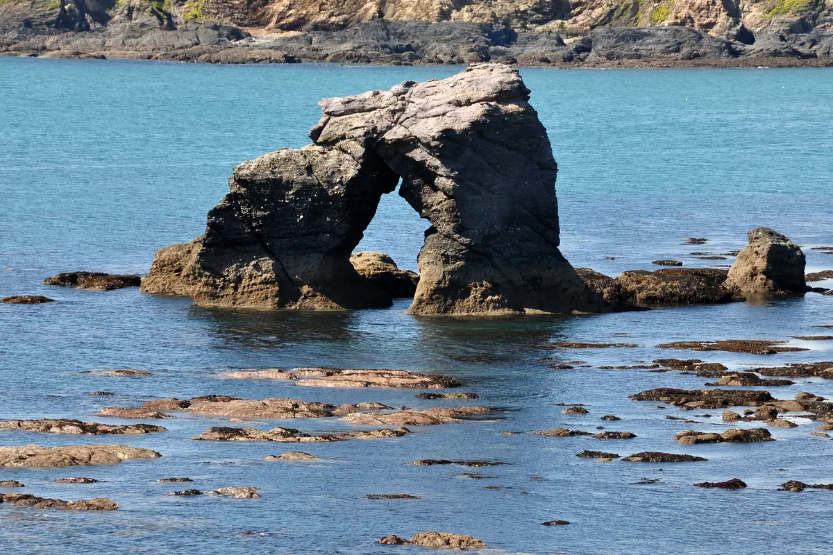 Thurlestone Rock, the arched stone standing offshore in Thurlestone Bay
